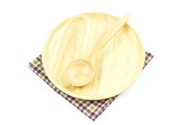 Cucchiaio in legno su tovaglia su sfondo bianco — Foto Stock