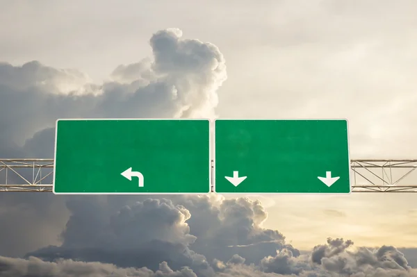 Empty green road sign against sky with clouds — Stock Photo, Image