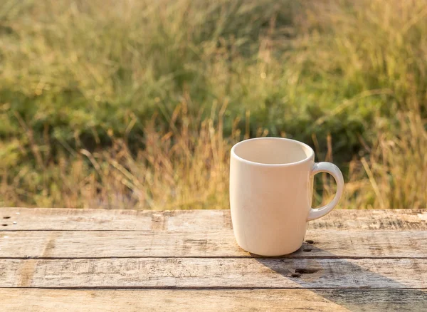 White Coffee cup on wooden table at morning sunlight — Stock Photo, Image