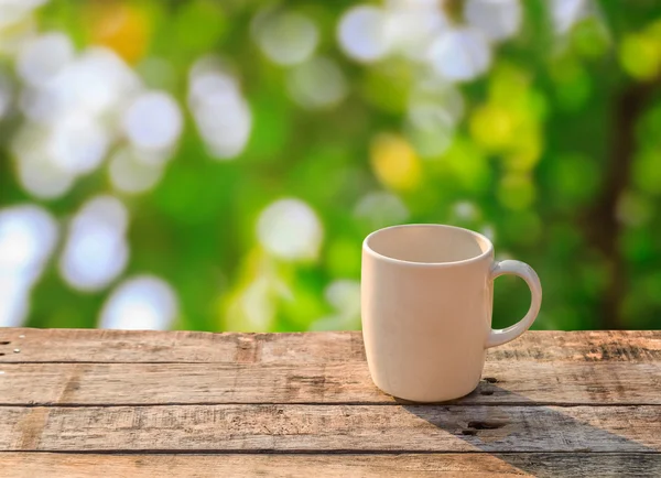 White coffee cup on wooden table at morning sunlight and bokeh b — Stock Photo, Image