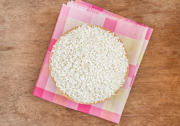 Rice in wooden bowl on wooden table — Stock Photo, Image