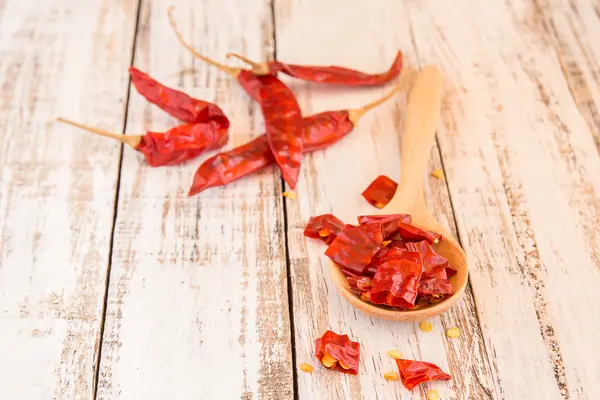 Dried Chili Peppers on wooden background — Stock Photo, Image