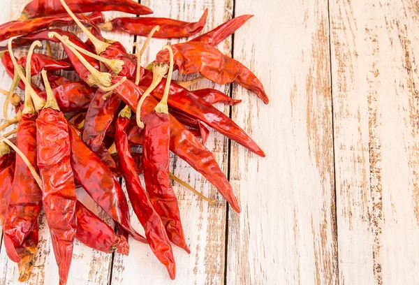 Dried Chili Peppers on wooden background — Stock Photo, Image