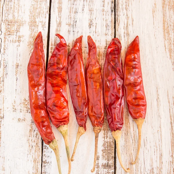 Dried Chili Peppers on wooden background — Stock Photo, Image