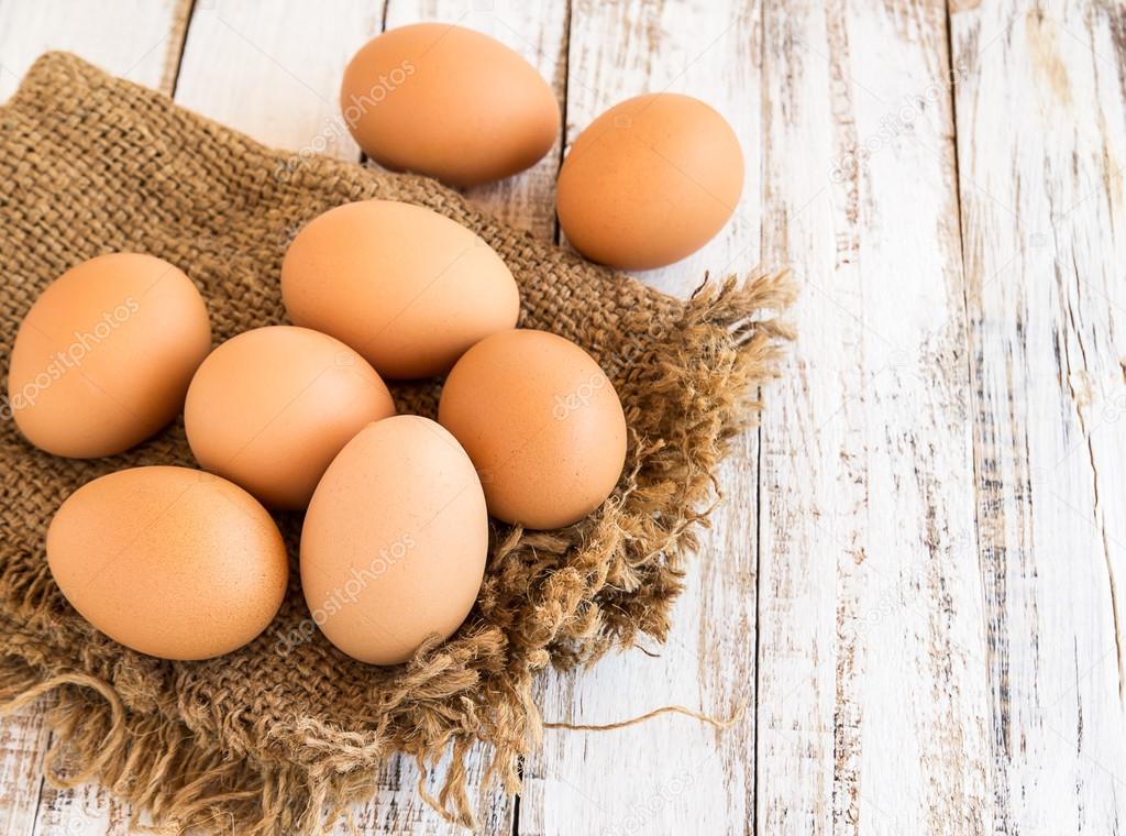 Chicken brown eggs on wooden background