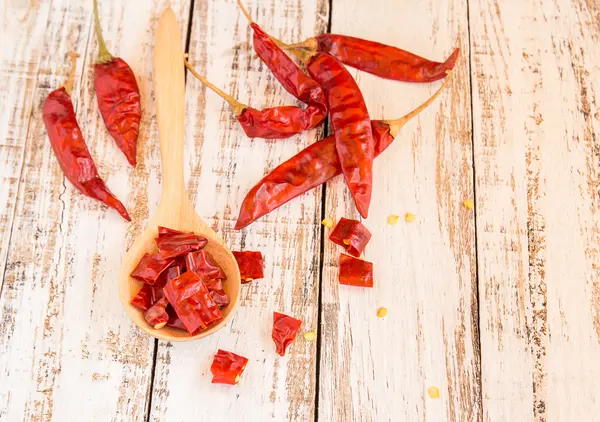 Dried chili peppers on wooden background — Stock Photo, Image