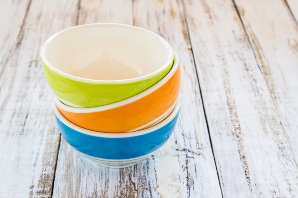 Colorful ceramic bowl on the wooden background — Stock Photo, Image