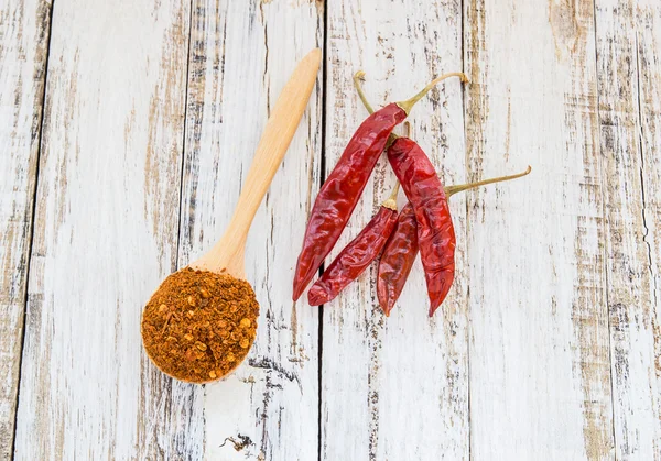 Powder chili in wooden spoon — Stock Photo, Image