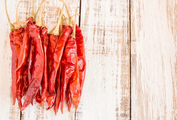 Dried chili peppers on wooden background — Stock Photo, Image