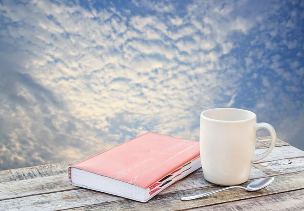 Notebook and coffee cup on wood background — Stock Photo, Image