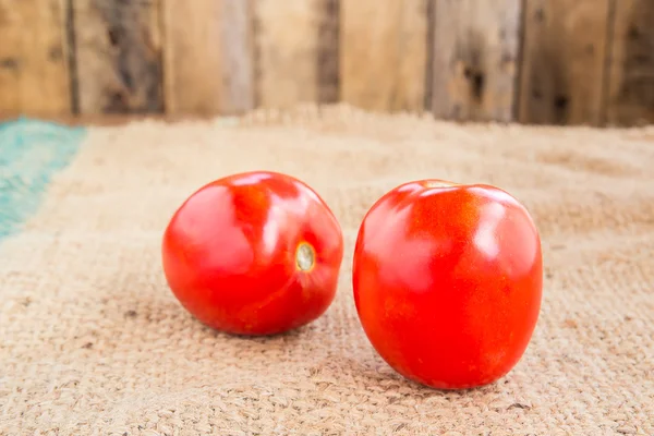 Close up Fresh red tomato on grunged  sack background — Stock Photo, Image