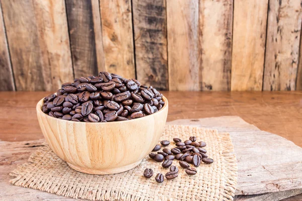 Roasted coffee beans in a wooden bowl — Stock Photo, Image