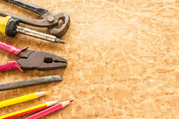 Tools and pencil on old paper background — Stock Photo, Image