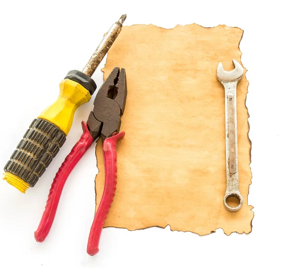 Tools and old paper on white background — Stock Photo, Image