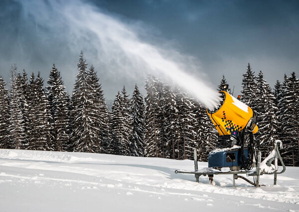 snow cannon, snowmaker, in winter mountain on ski resort