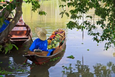 man in boat with fuits clipart