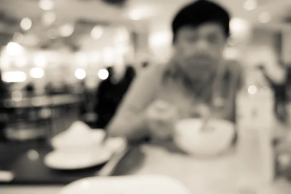 Blurred people eating in restaurant — Stock Photo, Image