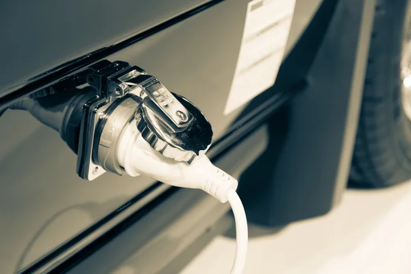 Power supply plugged into car — Stock Photo, Image