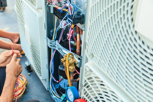 Technician preparing to install air conditioner