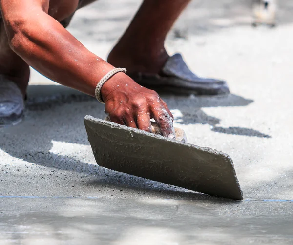 Plasterer concrete worker smooth the cement — Stock Photo, Image