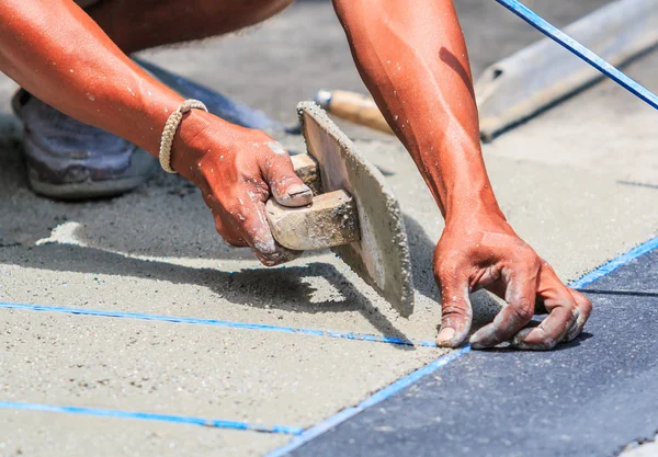 Plasterer concrete worker smooth the cement — Stock Photo, Image