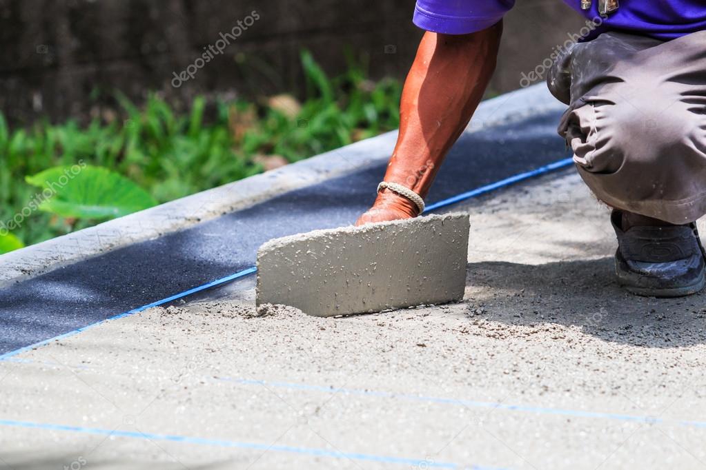 Plasterer concrete worker smooth the cement