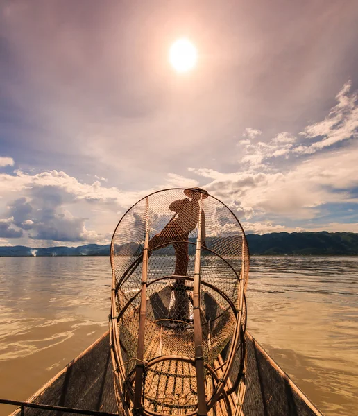 Fisherman on boat catching fish by traditional net — Stock Photo, Image