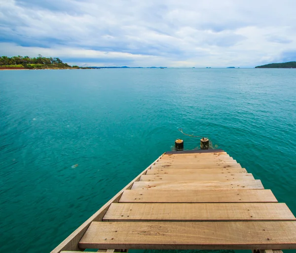 Wooden bridge into the sea — Stock Photo, Image