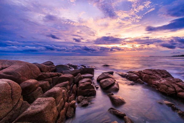 Sunset over rocks beach — Stock Photo, Image
