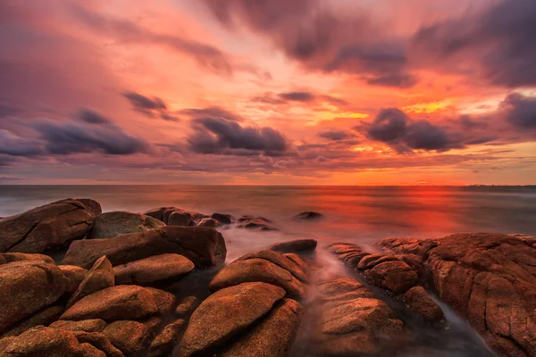 Sunset over rocks beach — Stock Photo, Image