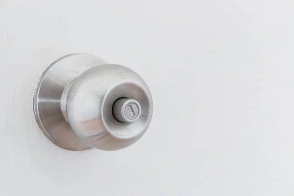 Detail of a metallic knob on white door — Stock Photo, Image