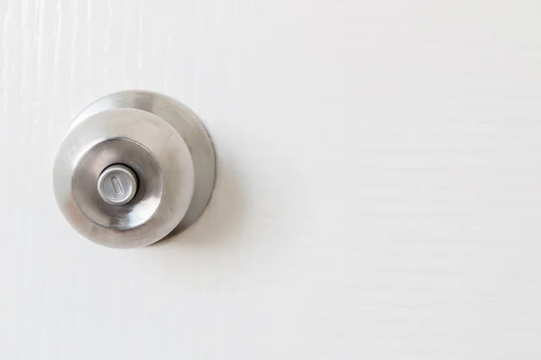 Detail of a metallic knob on white door — Stock Photo, Image