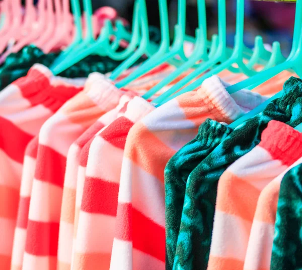 Clothes hang on a shelf — Stock Photo, Image