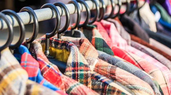 Clothes hang on a shelf — Stock Photo, Image