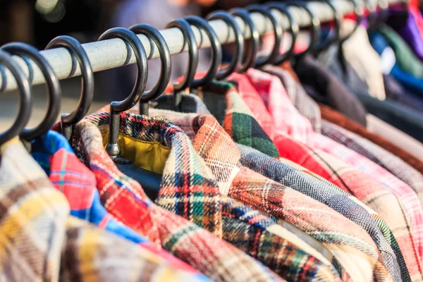 Clothes hang on a shelf — Stock Photo, Image