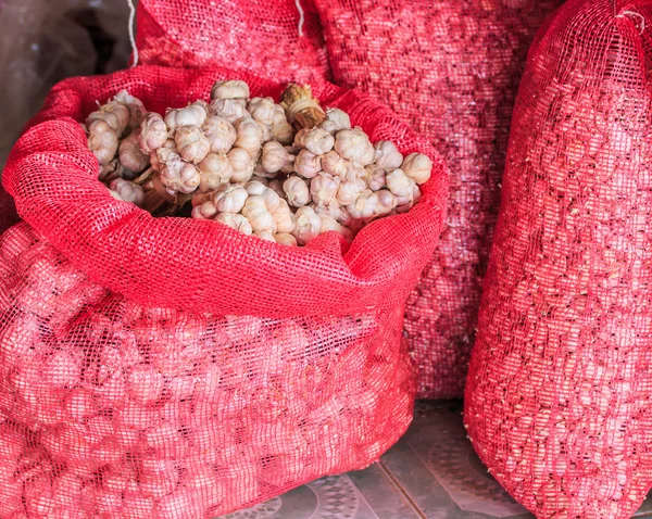 Garlic in bag or sack — Stock Photo, Image