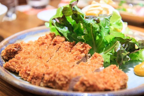 Japanese fried pork served with salad — Stock Photo, Image