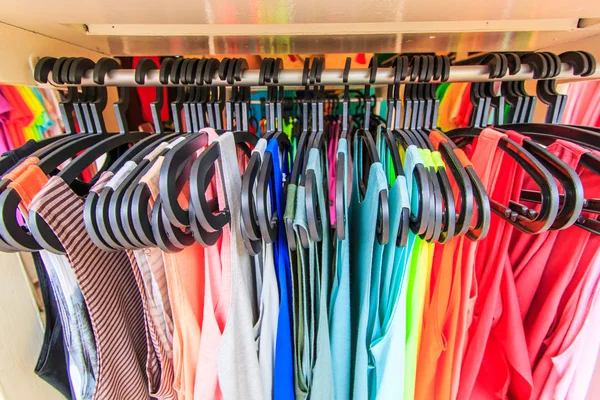 Clothes hang on a shelf — Stock Photo, Image