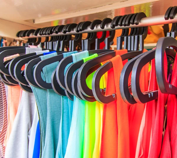 Clothes hang on a shelf — Stock Photo, Image