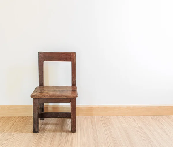 Old wooden chair on laminate flooring — Stock Photo, Image