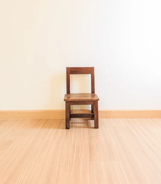 Old wooden chair on laminate flooring — Stock Photo, Image