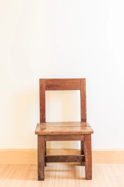 Old wooden chair on laminate flooring — Stock Photo, Image