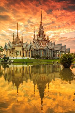 Wat thai at sunset in  Thailand clipart