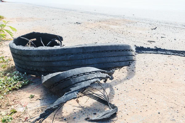 Pneu de borracha destruído na estrada — Fotografia de Stock