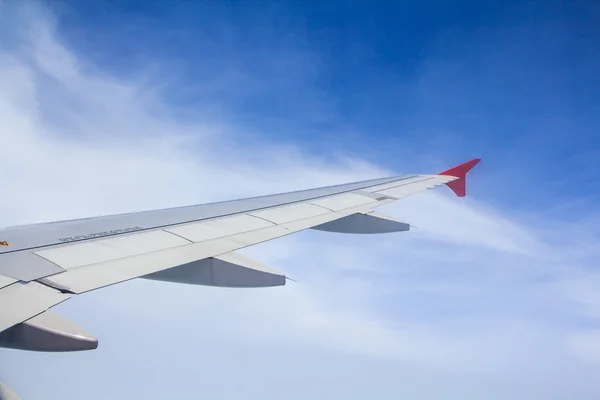 Airplane wing out of window — Stock Photo, Image