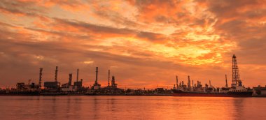 Oil refinery in evening clipart