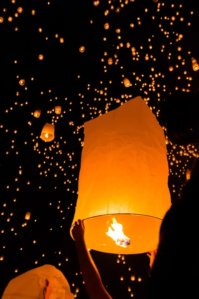 Floating lanterns and human hands — Stock Photo, Image
