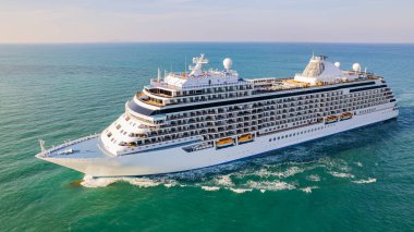 Cruise ships are sailing the seas, taking tourists on a journey around the world.