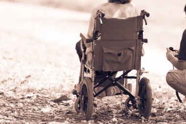 cripple sitting in wheelchair clipart