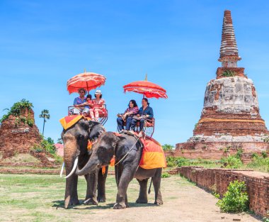 Tourists on an elephant ride tour clipart